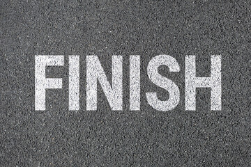 Finish sign on road. drawn with white color paint on asphalt.
