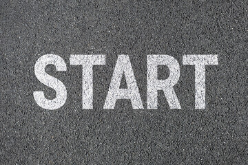 Start sign on road. drawn with white color paint on asphalt.