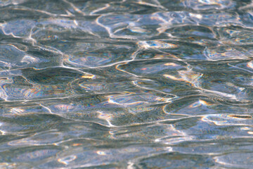 Clear water in the rays of the sun. Water background.