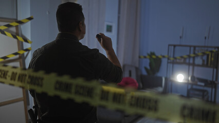 A man examines a living room at a cordoned off crime scene, adding suspense to the indoor setting.