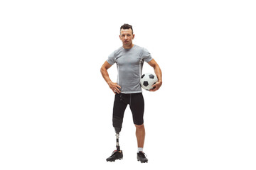 Athletic man with prosthetic leg confidently holding soccer ball, showing determination and fitness isolated on transparent background. Concept of inclusive sport, motivation, heath care, endurance