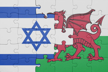 puzzle with the colourful national flag of wales and flag of israel.