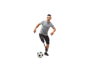 Innovative athlete. Fit soccer player with high-tech prosthetic leg in motion with football ball, training isolated on transparent background. Inclusive sport, motivation, heathcare, endurance concept