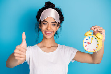 Portrait of pretty young woman thumb up alarm wear pajama isolated on blue color background