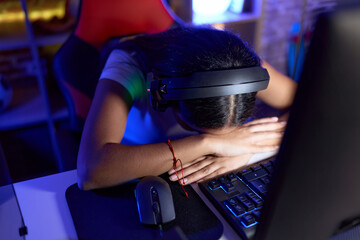 Young arab woman streamer stressed using computer at gaming room