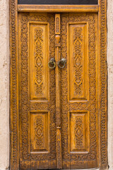 Wooden door of old houses in Itchan Kala, Khiva