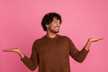 Photo of positive nice man wear trendy brown clothes recommend look empty space isolated on pink color background - Powered by Adobe