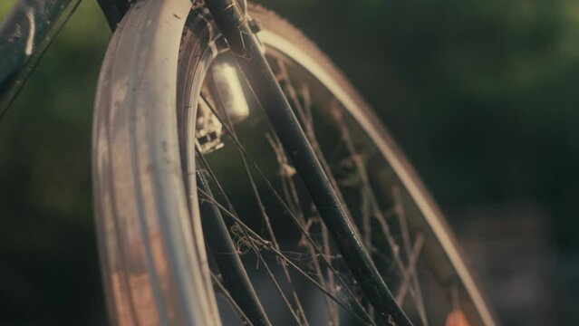 Vintage bicycle wheel with dynamo, metal spokes, aluminium mudguard, old push bike