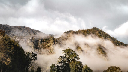 Foggy Mist Enshrouded The Mountains In The Morning In New Zealand