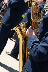 A man plays the saxophone, close-up.