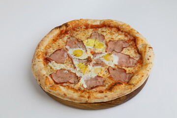 Carbonara pizza with bacon and egg on wooden board isolated on a white background