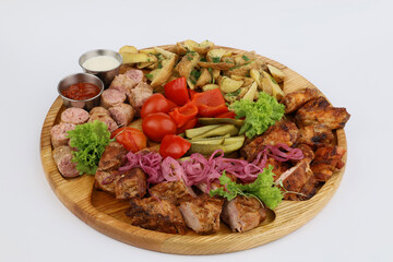 Food for a holiday for a large company. Hot meat snacks for beer served on wooden dish board on a white background