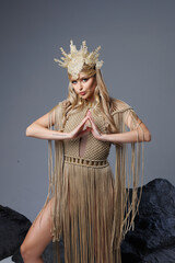 Beautiful bvlond lady in Greek clothes, 
a girl in a knitted macrame beige dress, bodysuit, gold...