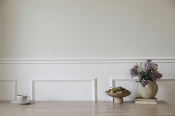 Breakfast Scandi spring interior still life, home design. White ceramic vase with blooming lilacs...