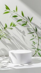 A white vase filled with flowers sits elegantly on a table next to a vibrant green plant