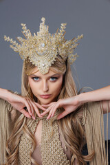 Beautiful bvlond lady in Greek clothes, 
a girl in a knitted macrame beige dress, bodysuit, gold...