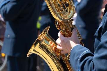 A man plays the saxophone, close-up.