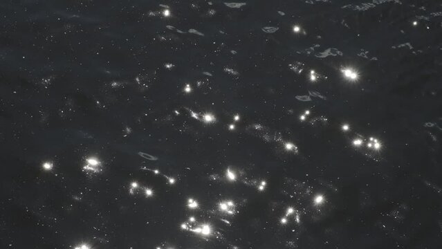 Abstract sunlight glints on the surface of waves in a tranquil summer river. Water sparkling ripples Natural sun glare on the water. Slow motion
