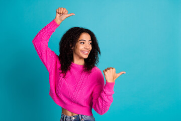 Portrait of nice young girl look point fingers empty space wear pink pullover isolated on turquoise color background