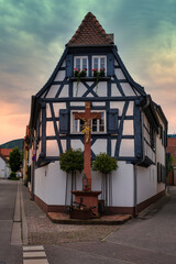 A cozy little half-timbered house in the old town of Maikammer at sunset