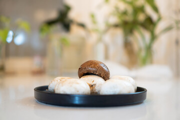 fresh portobello mushrooms on a black plate