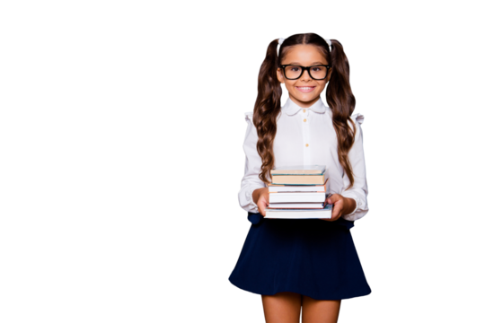Glad positive glad nice smart cute small little girl with curly pigtails in white blouse shirt and blue short skirt, carrying big book pile. Isolated over black background