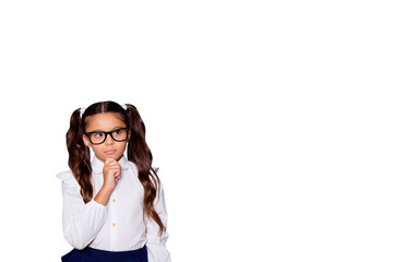 Portrait of nice cute genius pensive adorable lovely small little girl with curly pigtails in white formal blouse shirt, blue skirt, thinking. Isolated over black background