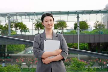 Confident Businesswoman Outdoors with Digital Tablet