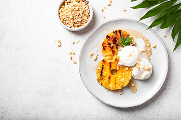 Grilled pineapples with icecream, tropical dessert