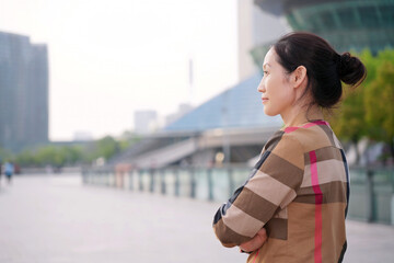 Confident Woman Gazing into the Distance Downtown