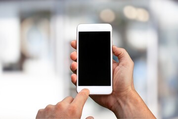 Modern phone in hand showing blank screen