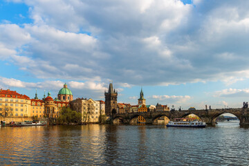 Naklejka premium The Vltava River in the center of the Czech Republic near the Charles Bridge on a cloudy spring day