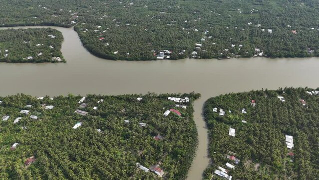 Amazing aerial view of Mekong Delta, vast coconut, palm, nipa tree field, irrigation system by canal with many river branch, water source for agriculture and waterway transport with cheap