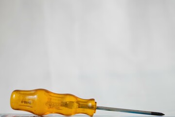 A yellow screwdriver with a silver tip