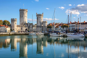 The picturesque old harbor of La Rochelle with historic towers and sailboats - Powered by Adobe