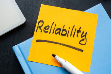 Reliability concept. Handwritten note on a yellow sticky note.