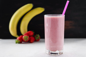 Strawberry and banana smoothie drink, blended cocktail, milkshake in a glass