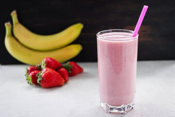Strawberry and banana smoothie drink, blended cocktail, milkshake in a glass
