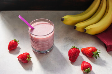 Strawberry and banana smoothie drink, blended cocktail, milkshake in a glass