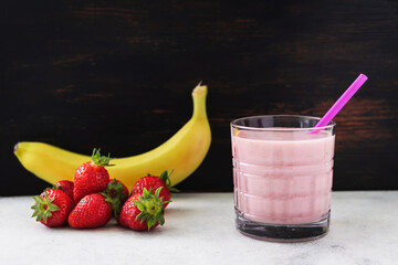 Strawberry and banana smoothie drink, blended cocktail, milkshake in a glass