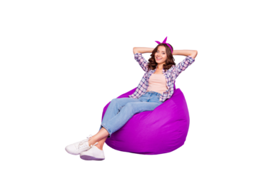 Full size portrait of attractive nice lady with her hairdo she look camera make white beaming smile hold hands behind head sit isolated on purple background in checkered shirt denim casual jeans