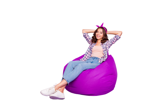 Full size portrait of attractive nice lady with her hairdo she look camera make white beaming smile hold hands behind head sit isolated on purple background in checkered shirt denim casual jeans
