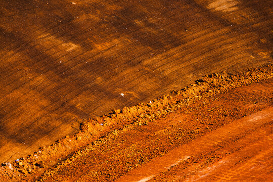 graded clay-rich dirt along a turn at a dirt race track