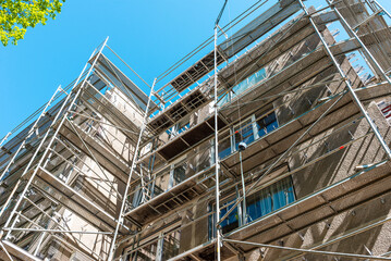Modern residential apartment building under construction. Reconstruction of a building. Summer day.