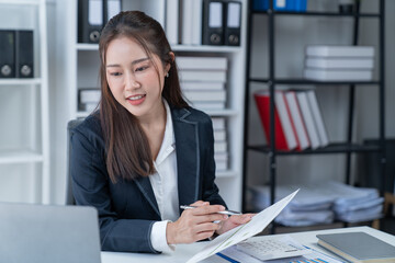 happy young businesswoman Asian siting on the chiar cheerful demeanor raise holding coffee cup smiling looking laptop screen.Making opportunities female working successful in the office.	
