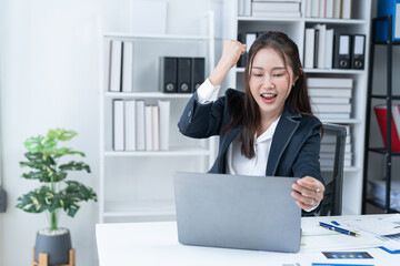 The Asian female business professional displayed a cheerful expression in her office.