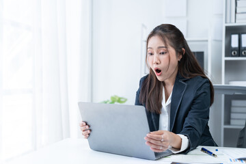 The Asian female business professional displayed a cheerful expression in her office.