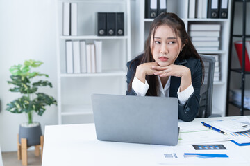 Stress at work, sitting with a stressed face, standing and stretching the body of an office woman.