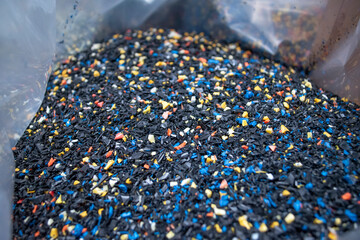 Recycled crushed plastic. Recycling and reuse of plastic. The problem of environmental pollution. Ecology and innovations. Various types of plastic.