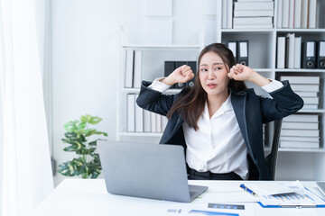 Stress at work, sitting with a stressed face, standing and stretching the body of an office woman.